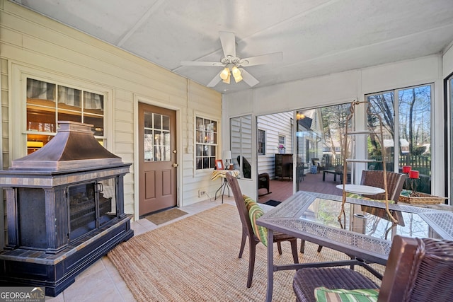 sunroom featuring ceiling fan