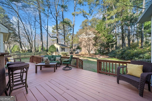 deck featuring outdoor lounge area and a storage shed