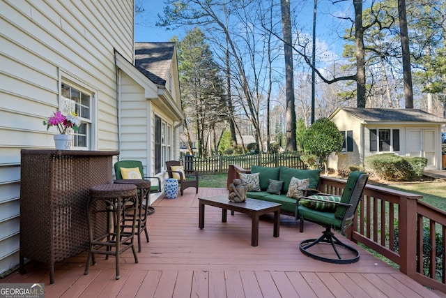 wooden deck featuring an outdoor structure and an outdoor hangout area