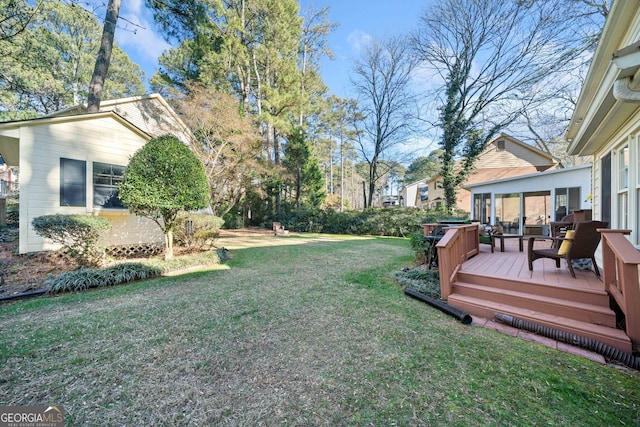 view of yard with a sunroom and a deck