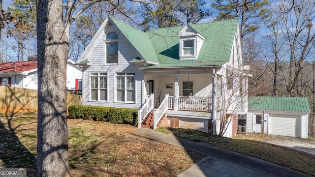 view of front of property with covered porch, an outdoor structure, and a garage