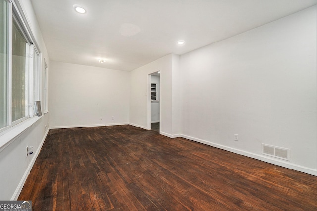 spare room featuring dark wood-type flooring