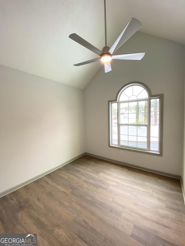 unfurnished room with ceiling fan, lofted ceiling, and light hardwood / wood-style flooring