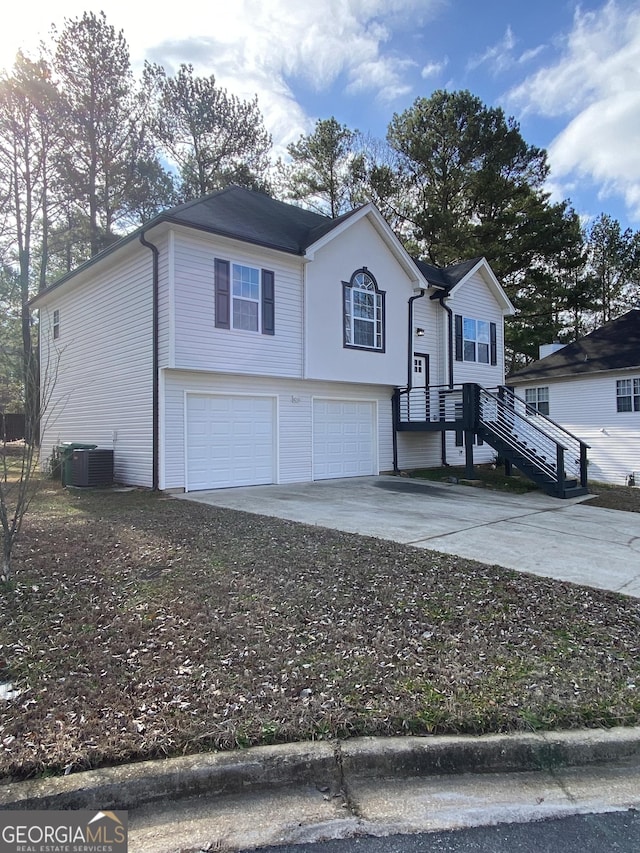 bi-level home featuring a garage and central air condition unit