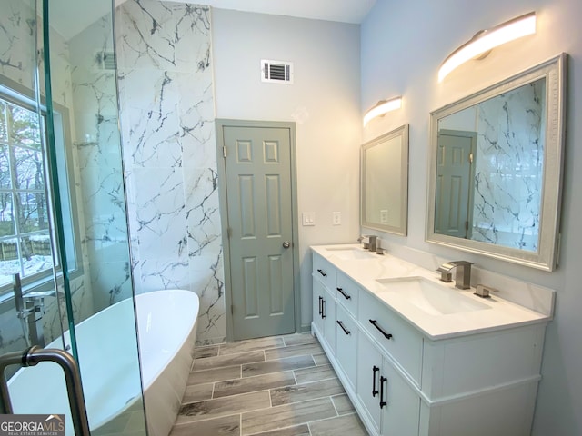 bathroom featuring vanity and a tub to relax in