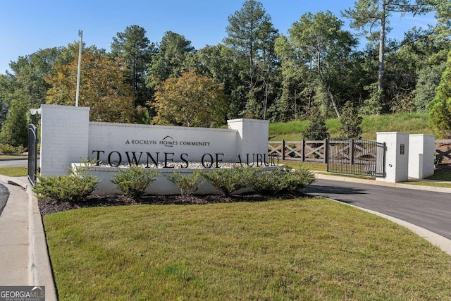 community / neighborhood sign with a lawn