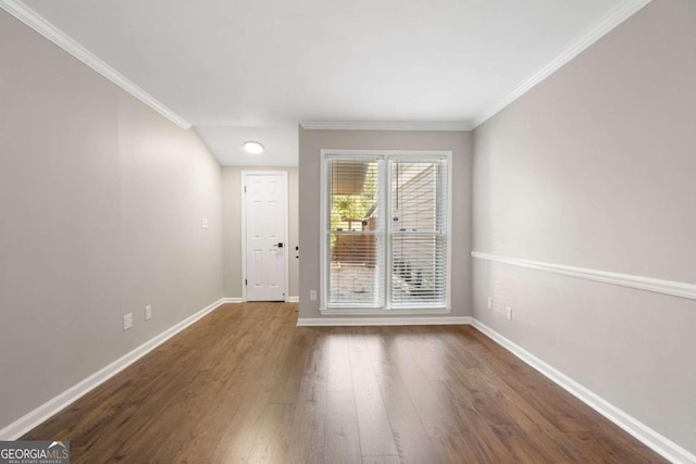 spare room featuring dark hardwood / wood-style floors and ornamental molding