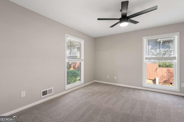 spare room featuring carpet flooring and ceiling fan