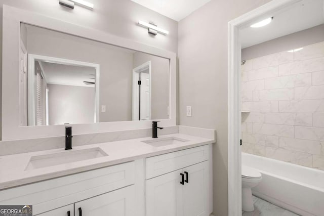 full bathroom with vanity, toilet, and tiled shower / bath combo