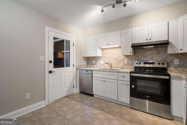 kitchen with tasteful backsplash, stainless steel appliances, sink, light tile patterned floors, and white cabinetry