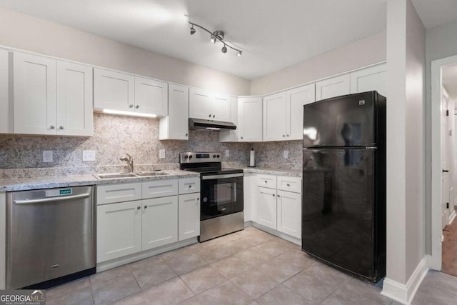 kitchen with sink, light stone countertops, appliances with stainless steel finishes, tasteful backsplash, and white cabinetry