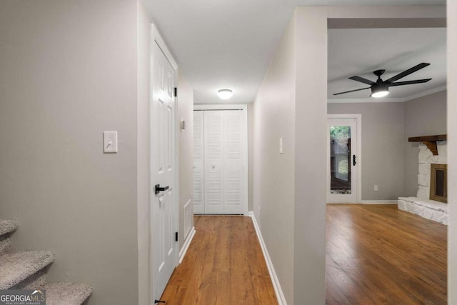 hall with crown molding and hardwood / wood-style flooring