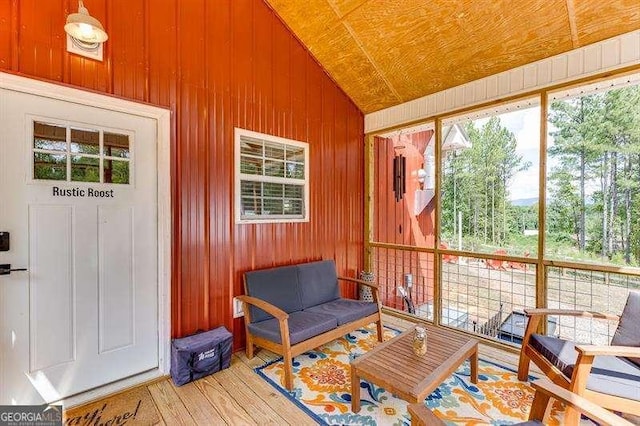 sunroom / solarium featuring lofted ceiling