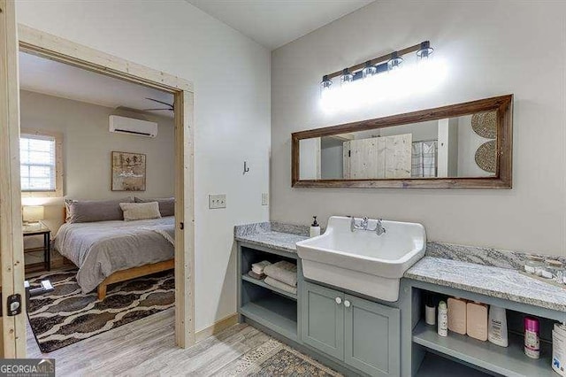 bathroom featuring an AC wall unit, vanity, and hardwood / wood-style flooring