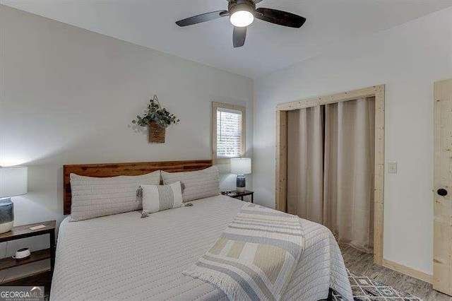 bedroom with ceiling fan and wood-type flooring