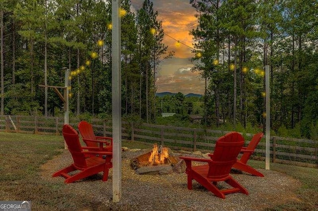 playground at dusk featuring a fire pit