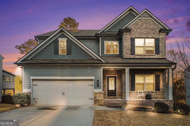 craftsman-style home featuring covered porch and a garage