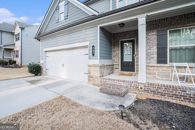 doorway to property with a garage