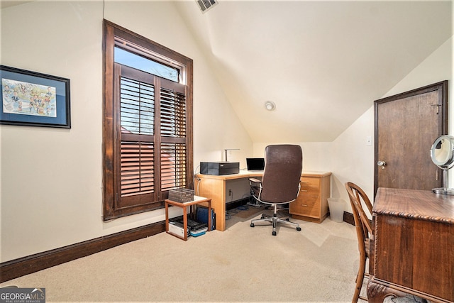 carpeted office featuring lofted ceiling