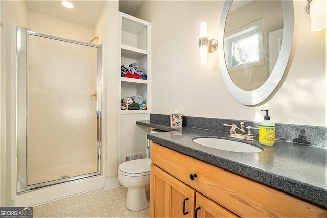 bathroom featuring vanity, toilet, and walk in shower