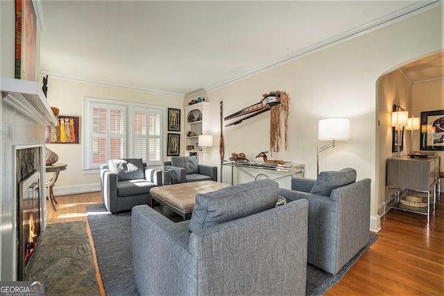 living room with dark wood-type flooring and crown molding