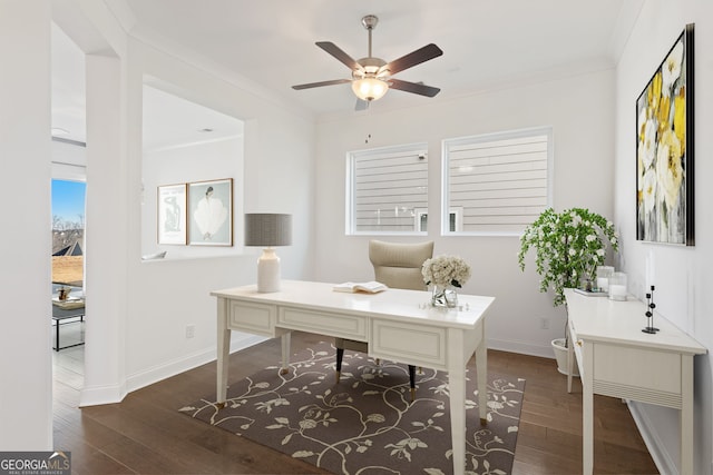 office area with dark wood-type flooring, ornamental molding, and ceiling fan