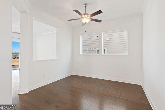 spare room with crown molding, dark wood-type flooring, and ceiling fan