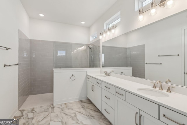 bathroom with vanity and a tile shower