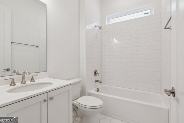 full bathroom featuring vanity, tile patterned flooring, toilet, and tiled shower / bath