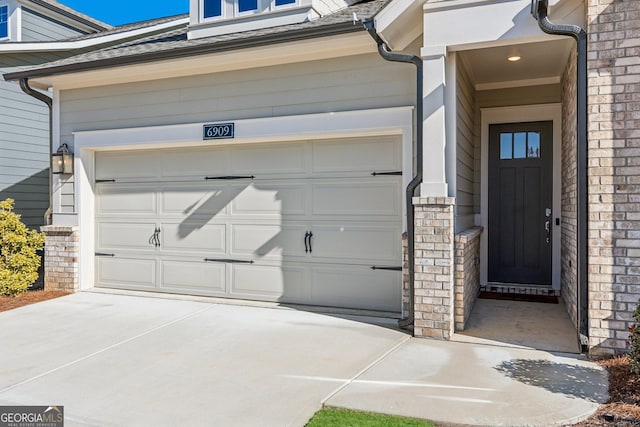 doorway to property featuring a garage