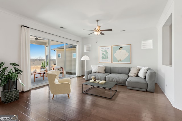 living room featuring crown molding, dark hardwood / wood-style floors, and ceiling fan