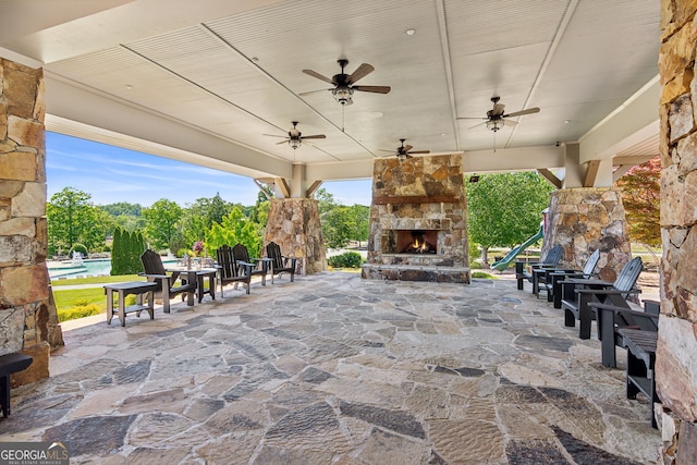 view of patio / terrace featuring an outdoor stone fireplace