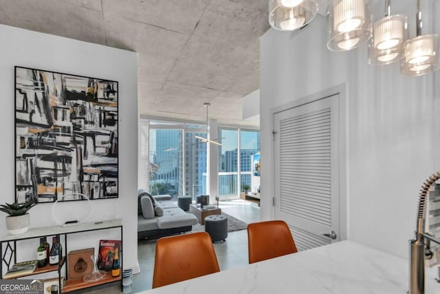 living room featuring floor to ceiling windows and a chandelier