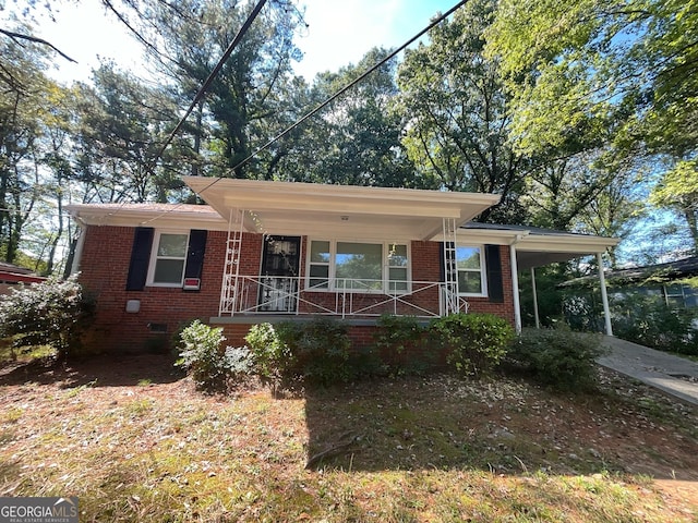 view of front of property with a carport and a porch