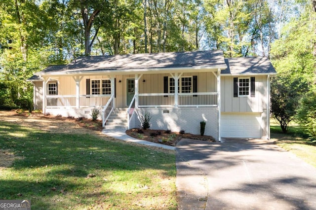 ranch-style house featuring a porch, a garage, and a front lawn