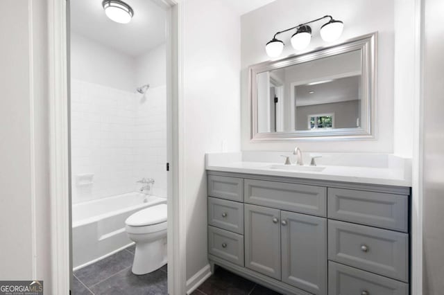 full bathroom featuring tile patterned floors, vanity, toilet, and tiled shower / bath combo