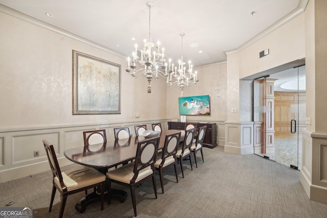 dining space with ornamental molding, light carpet, and an inviting chandelier