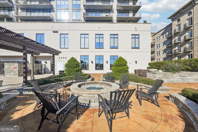 view of patio featuring a pergola and an outdoor fire pit