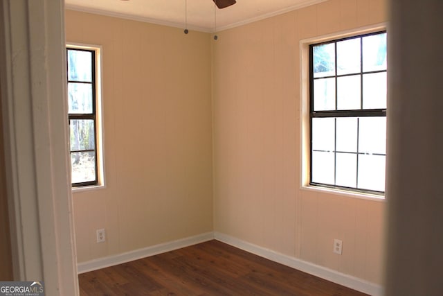 spare room featuring ornamental molding, dark wood-type flooring, and ceiling fan