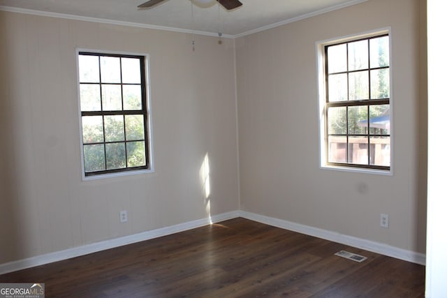 empty room featuring ceiling fan, ornamental molding, and dark hardwood / wood-style flooring