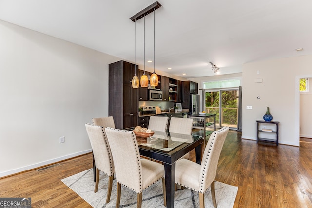 dining space with dark hardwood / wood-style floors