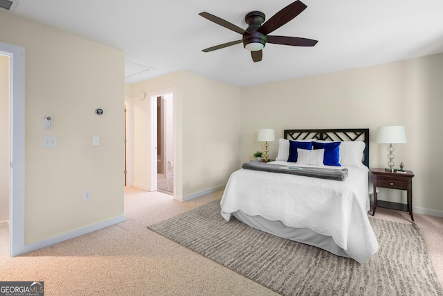 carpeted bedroom with ceiling fan and connected bathroom