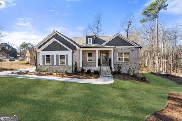 craftsman inspired home with a porch and a front yard