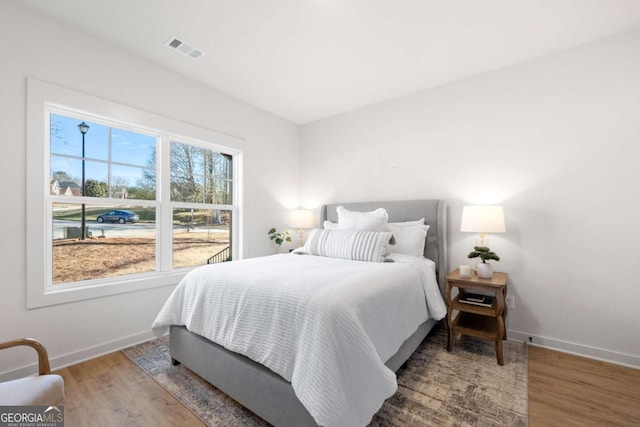 bedroom with hardwood / wood-style floors