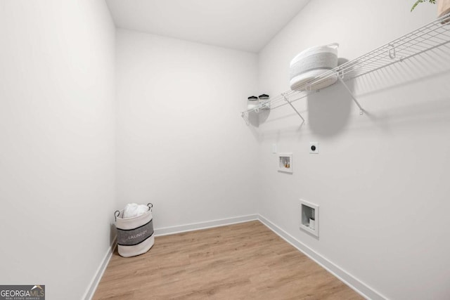 clothes washing area with electric dryer hookup, hookup for a washing machine, and hardwood / wood-style floors