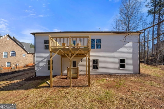 rear view of house featuring a deck