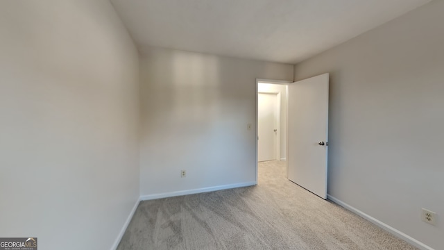 empty room featuring light carpet