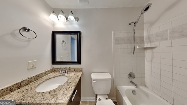 full bathroom with vanity, tiled shower / bath combo, and toilet