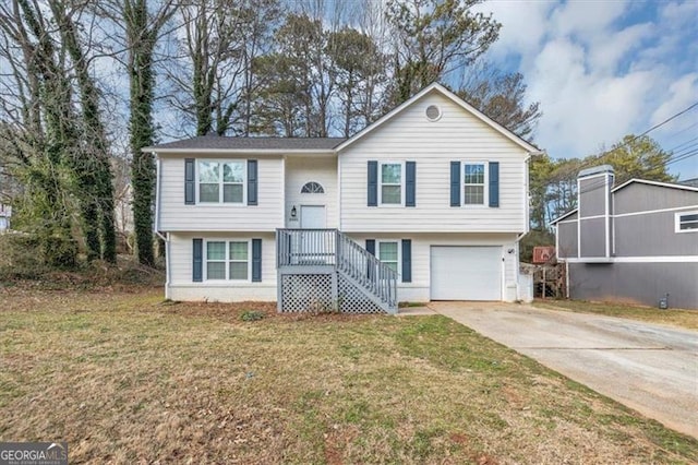 raised ranch with a garage and a front lawn