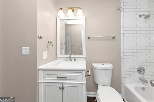 full bathroom featuring vanity, toilet, and tiled shower / bath combo